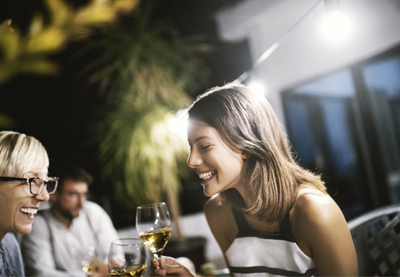 Freunde feiern abends im Wintergarten.