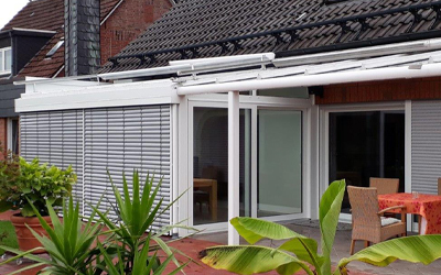 Wintergarten mit außenliegendem Raffstore als Sicht- und Sonnenschutz