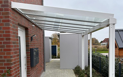 Hauseingangsüberdachung mit Glasdach und weißen Aluminiumprofilen