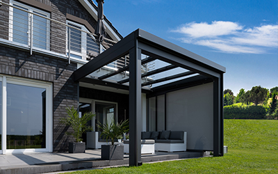 Freistehende Terrassenüberdachung aus Aluminium und Glas mit Sitzbereich