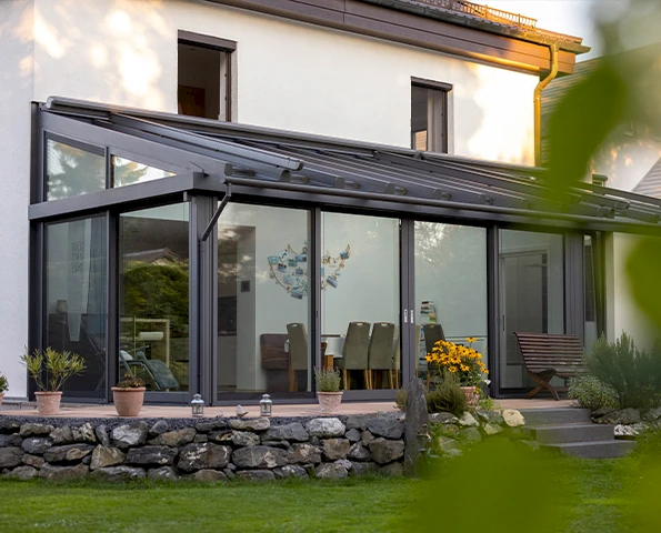 Moderner Wintergarten mit großen Glasflächen und Aluminiumprofilen am Wohnhaus